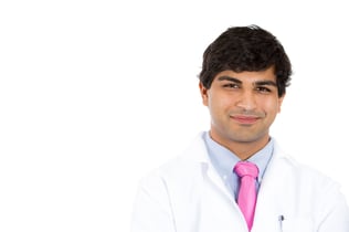 A closeup portrait of a smiling healthcare professional isolated on white background, with copy space