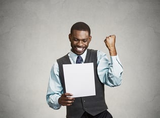 Closeup portrait happy excited young business man executive looking monthly statement glad to pay off bills isolated grey background. Positive emotion facial expression. Financial success good news-1