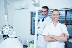 Portrait of smiling male and female dentists