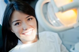 Young woman portrait visiting the dentist and smiling